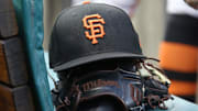 San Francisco Giants hat and glove on the bench