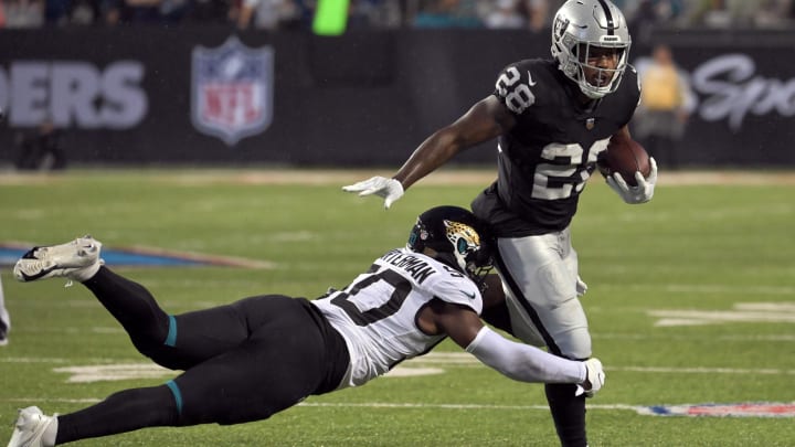 Linebacker Shaquille Quarterman lays out for a tackle of former Raiders  and current Packers running back Josh Jacobs.