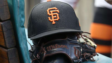 San Francisco Giants hat and glove on the bench