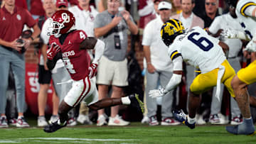 Oklahoma Sooners wide receiver Deion Burks (4) runs past Michigan Wolverines defensive back Brandyn Hillman (6) during a college football game between the University of Oklahoma Sooners (OU) and the University of Michigan Wolverines at Gaylord Family Ð Oklahoma Memorial Stadium in Norman, Okla., Saturday, Sept. 6, 2025.
