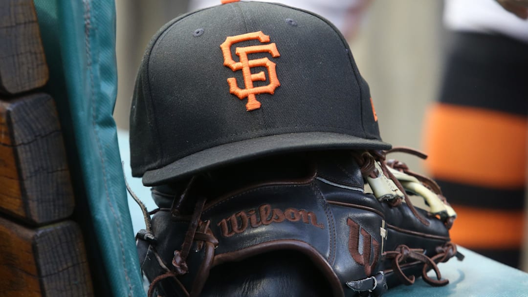 San Francisco Giants hat and glove on the bench against the Pittsburgh Pirates during the first inning at PNC Park.