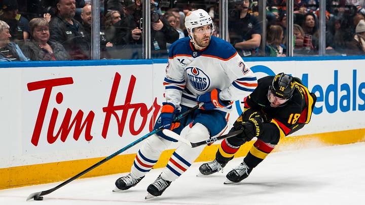 Jan 17, 2026; Vancouver, British Columbia, CAN; Vancouver Canucks forward Drew O'Connor (18) stick checks Edmonton Oilers defenseman Evan Bouchard (2) in the second period at Rogers Arena. Mandatory Credit: Bob Frid-Imagn Images