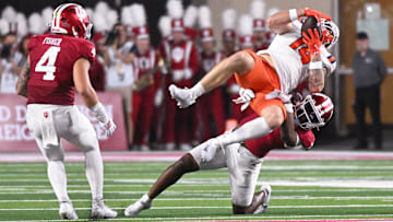 Sep 20, 2025; Bloomington, Indiana, USA; Indiana Hoosiers defensive back Louis Moore (7) tackles Illinois Fighting Illini tight end Cole Rusk (14) during the first half at Memorial Stadium. Mandatory Credit: Robert Goddin-Imagn Images