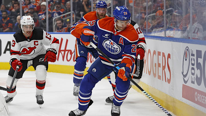 Nov 4, 2024; Edmonton, Alberta, CAN; Edmonton Oilers defensemen Darnell Nurse (25) clears the puck in front of New Jersey Devils forward Nico Hischier (13) and forward Stefan Noesen (11) during the second period at Rogers Place. Mandatory Credit: Perry Nelson-Imagn Images Nov 4, 2024; Edmonton, Alberta, CAN; Edmonton Oilers defensemen Darnell Nurse (25) clears the puck in front of New Jersey Devils forward Nico Hischier (13) and forward Stefan Noesen (11) during the second period at Rogers Place. Mandatory Credit: Perry Nelson-Imagn Images