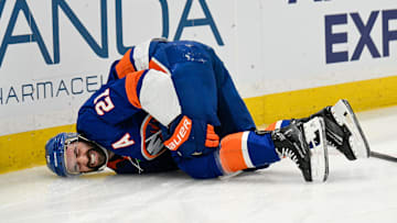 Nov 28, 2025; Elmont, New York, USA; New York Islanders center Kyle Palmieri (21) falls to the ice after an injury against the Philadelphia Flyers during the second period at UBS Arena. Mandatory Credit: Dennis Schneidler-Imagn Images