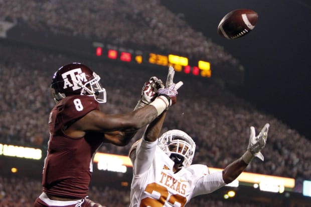 Texas Longhorns cornerback Eddie Aboussie (23) breaks up a pass intended for Texas A&M Aggies receiver Jeff Fuller (8). 