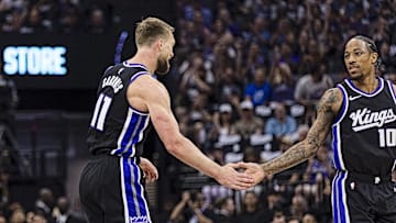 Apr 13, 2025; Sacramento, California, USA;  Sacramento Kings center Domantas Sabonis (11) is congratulated by forward DeMar DeRozan (10) after he hit a three-point shot against the Phoenix Suns during the first quarter at Golden 1 Center. Mandatory Credit: John Hefti-Imagn Images