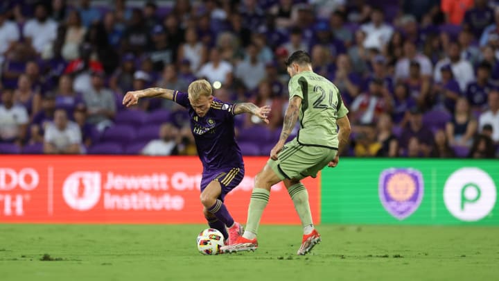 Jun 15, 2024; Orlando, Florida, USA; Orlando City midfielder Dagur Thorhallsson (17) controls the ball from LAFC defender Ryan Hollingshead (24) in the first half at Inter&Co Stadium. Mandatory Credit: Nathan Ray Seebeck-USA TODAY Sports