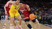 Mar 16, 2025; Indianapolis, IN, USA; Wisconsin Badgers guard John Tonje (9) drives to the hoop past Michigan Wolverines forward Will Tschetter (42) during the second half during the 2025 Big Ten Championship Game at Gainbridge Fieldhouse. Mandatory Credit: Trevor Ruszkowski-Imagn Images