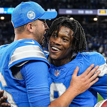 Detroit Lions quarterback Jared Goff (16) hugs wide receiver Jameson Williams (9) 