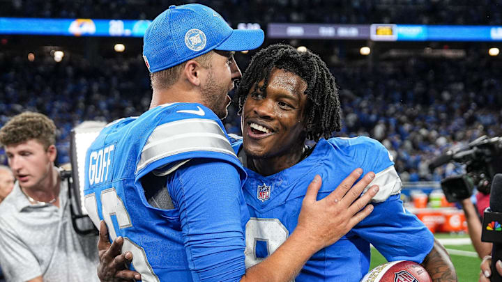 Detroit Lions quarterback Jared Goff (16) hugs wide receiver Jameson Williams (9) 