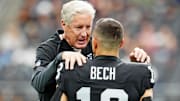 Oct 12, 2025; Paradise, Nevada, USA; Las Vegas Raiders wide receiver Jack Bech (18) and Las Vegas Raiders head coach Pete Carroll talk before the game against the Tennessee Titans at Allegiant Stadium. Mandatory Credit: Stephen R. Sylvanie-Imagn Images