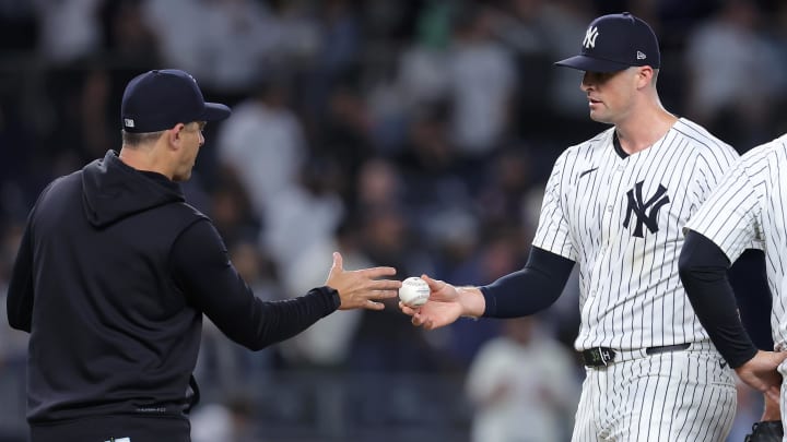 May 20, 2024; Bronx, New York, USA; New York Yankees relief pitcher Clay Holmes (35) hands the ball to manager Aaron Boone (17) after being taken out of the game against the Seattle Mariners during the ninth inning at Yankee Stadium. Mandatory Credit: Brad Penner-USA TODAY Sports