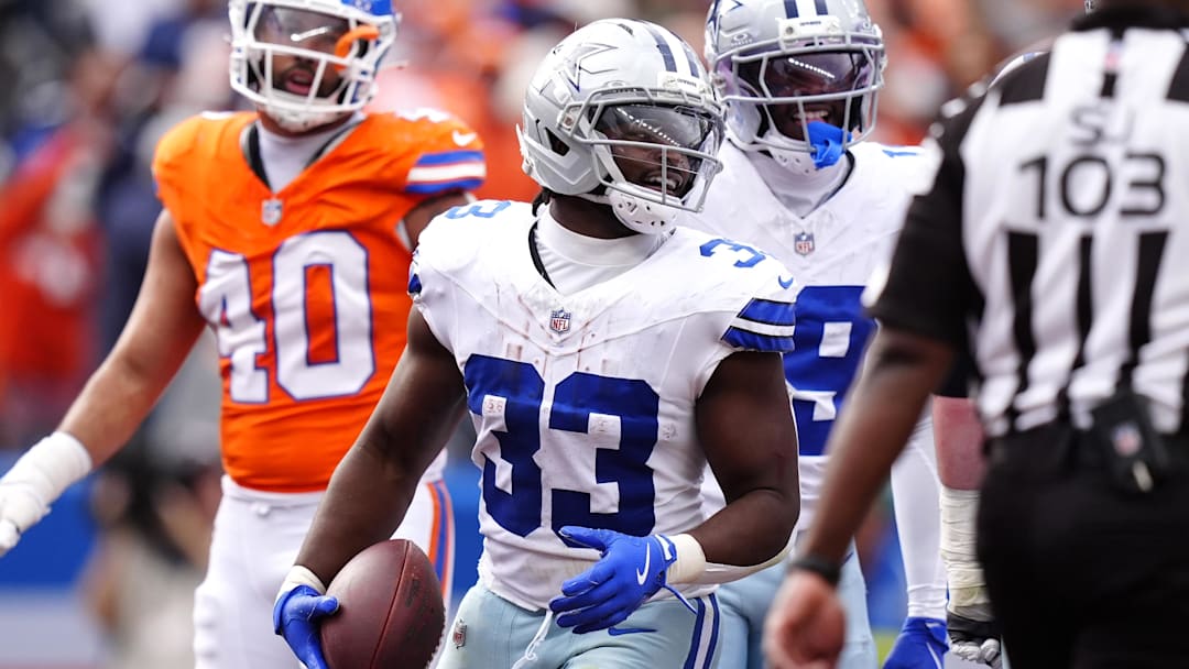 Oct 26, 2025; Denver, Colorado, USA; Dallas Cowboys running back Javonte Williams (33) celebrates after scoring a touchdown against the Denver Broncos in the second quarter at Empower Field at Mile High. Mandatory Credit: Ron Chenoy-Imagn Images