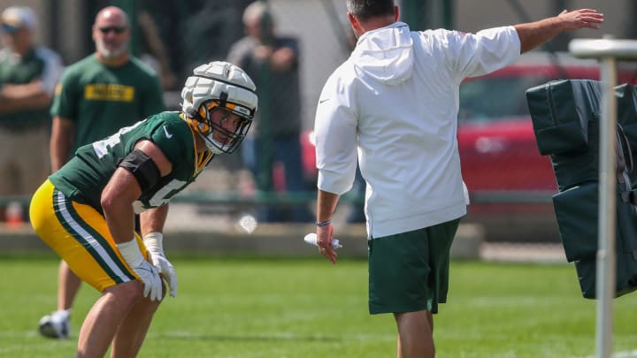 Green Bay Packers linebacker Kristian Welch (54) receives instruction from linebackers coach Anthony Campanile at training camp.