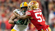 January 20, 2024; Santa Clara, CA, USA; San Francisco 49ers linebacker Dre Greenlaw (57) tackles Green Bay Packers running back Emanuel Wilson (31) during the first quarter in a 2024 NFC divisional round game at Levi's Stadium. 