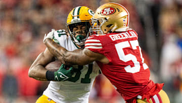 January 20, 2024; Santa Clara, CA, USA; San Francisco 49ers linebacker Dre Greenlaw (57) tackles Green Bay Packers running back Emanuel Wilson (31) during the first quarter in a 2024 NFC divisional round game at Levi's Stadium. 