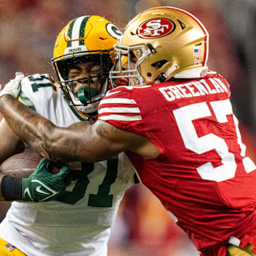 January 20, 2024; Santa Clara, CA, USA; San Francisco 49ers linebacker Dre Greenlaw (57) tackles Green Bay Packers running back Emanuel Wilson (31) during the first quarter in a 2024 NFC divisional round game at Levi's Stadium. 