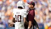 Sep 14, 2024; Gainesville, Florida, USA; Texas A&M Aggies quarterback Marcel Reed (10) celebrates with Texas A&M Aggies offensive coordinator Collin Klein after a touchdown against the Florida Gators during the first half at Ben Hill Griffin Stadium. Mandatory Credit: Matt Pendleton-Imagn Images
