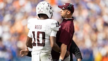 Sep 14, 2024; Gainesville, Florida, USA; Texas A&M Aggies quarterback Marcel Reed (10) celebrates with Texas A&M Aggies offensive coordinator Collin Klein after a touchdown against the Florida Gators during the first half at Ben Hill Griffin Stadium. Mandatory Credit: Matt Pendleton-Imagn Images