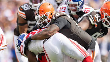 Sep 22, 2024; Cleveland, Ohio, USA; Cleveland Browns defensive tackle Quinton Jefferson (72) tackles New York Giants running back Devin Singletary (26) during the second quarter at Huntington Bank Field. Mandatory Credit: Scott Galvin-Imagn Images