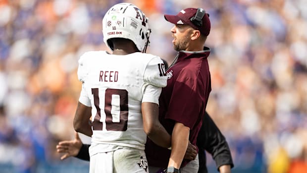 Texas A&M quarterback Marcel Reed celebrates with Aggies offensive coordinator Collin Klein after a touchdown against Florida