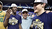Mar 14, 2015; Greensboro, NC, USA; Notre Dame Fighting Irish guard Jerian Grant (22) and head coach Mike Brey and guard/forward Pat Connaughton (24) celebrate after the game. Fighting Irish defeated the North Carolina Tar Heels 90-82 in the championship game of the ACC Tournament at Greensboro Coliseum. 