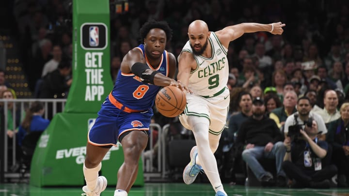 Apr 11, 2024; Boston, Massachusetts, USA;  Boston Celtics guard Derrick White (9) tries to steal the ball from New York Knicks forward OG Anunoby (8) during the first half at TD Garden. Mandatory Credit: Bob DeChiara-USA TODAY Sports