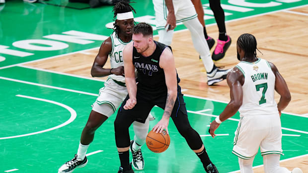 Jun 6, 2024; Boston, Massachusetts, USA; Dallas Mavericks guard Luka Doncic (77) controls the ball against Boston Celtics guard Jrue Holiday (4) in the second quarter during game one of the 2024 NBA Finals at TD Garden. Mandatory Credit: David Butler II-USA TODAY Sports
