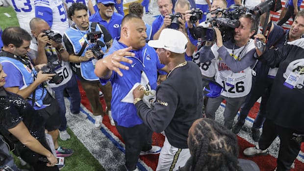Brigham Young Cougars head coach Kalani Sitake and Colorado Buffaloes head coach Deion Sanders greet on the field after the g