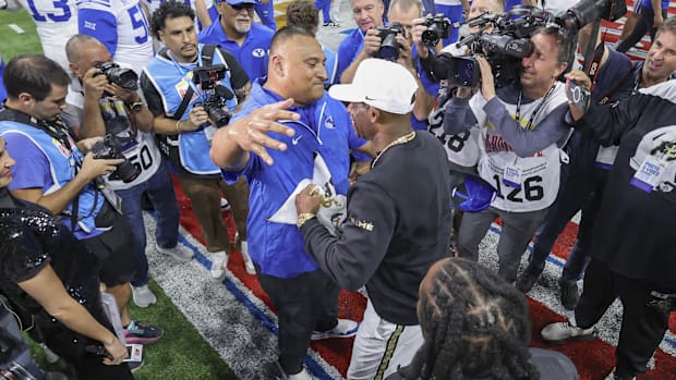  Brigham Young Cougars head coach Kalani Sitake and Colorado Buffaloes head coach Deion Sanders greet on the field after the 