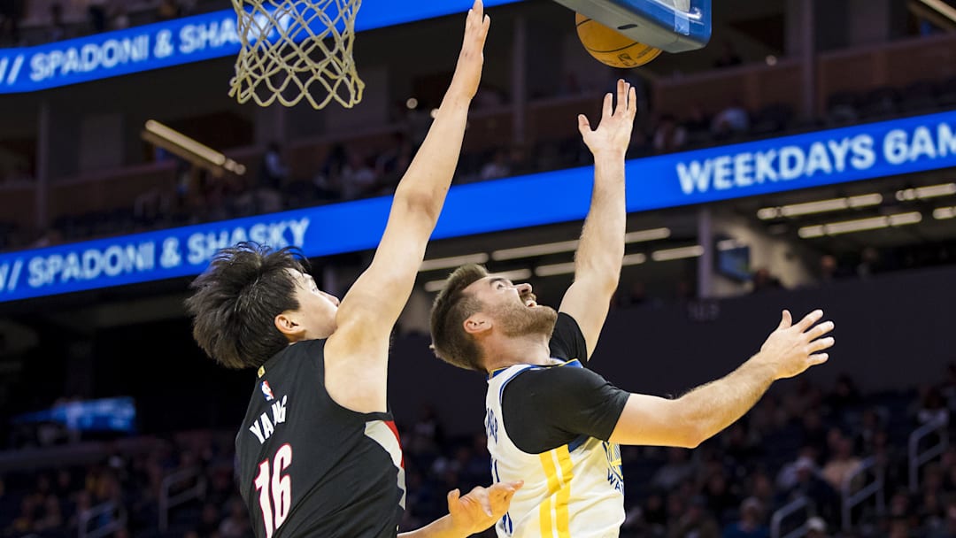 Oct 8, 2025; San Francisco, California, USA;  Golden State Warriors guard Pat Spencer (61) shoots as Portland Trail Blazers center Yang Hansen (16) defends during the fourth quarter at Chase Center. Mandatory Credit: John Hefti-Imagn Images