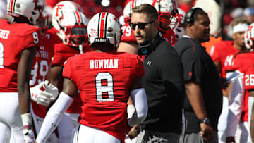Oct 20, 2018; Lubbock, TX, USA; Texas Tech Red Raiders head coach Kliff Kingsbury (ceneter) talks to punt returner De'Quan Bowman (8) during the game against the Kansas Jayhawks at Jones AT&T Stadium. Texas Tech defeated Kansas 48-16.  Mandatory Credit: Michael C. Johnson-Imagn Images