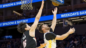 Oct 8, 2025; San Francisco, California, USA;  Golden State Warriors guard Pat Spencer (61) shoots as Portland Trail Blazers center Yang Hansen (16) defends during the fourth quarter at Chase Center. Mandatory Credit: John Hefti-Imagn Images