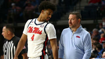 Jan 4, 2025; Oxford, Mississippi, USA; Mississippi Rebels head coach Chris Beard (right) talks with forward Jaemyn Brakefield (4) during the second half against the Georgia Bulldogs at The Sandy and John Black Pavilion at Ole Miss. Mandatory Credit: Petre Thomas-Imagn Images