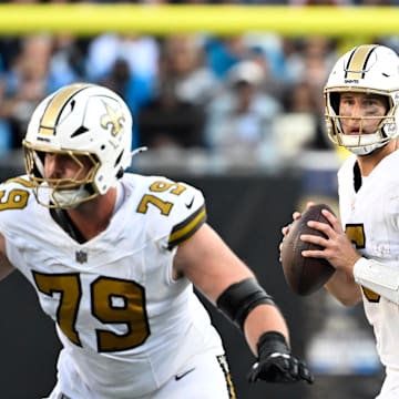 Nov 9, 2025; Charlotte, North Carolina, USA;  New Orleans Saints quarterback Tyler Shough (6) looks to pass as center Luke Fortner (79) blocks in the fourth quarter at Bank of America Stadium. Mandatory Credit: Bob Donnan-Imagn Images