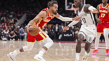 Trae Young dribbles the basketball