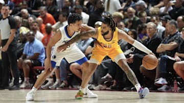 Jul 10, 2025; Las Vegas, NV, USA; Los Angeles Lakers guard RJ Davis (26) dribbles against Dallas Mavericks guard Ryan Nembhard (9) in the first quarter of their game at Thomas & Mack Center. Mandatory Credit: Candice Ward-Imagn Images