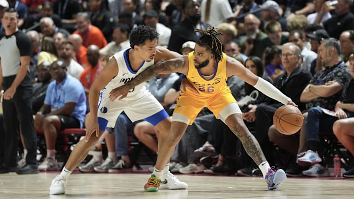 Jul 10, 2025; Las Vegas, NV, USA; Los Angeles Lakers guard RJ Davis (26) dribbles against Dallas Mavericks guard Ryan Nembhard (9) in the first quarter of their game at Thomas & Mack Center. Mandatory Credit: Candice Ward-Imagn Images