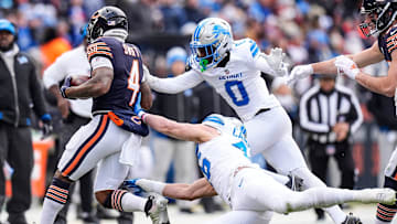 Detroit Lions cornerback Terrion Arnold (0) and linebacker Jack Campbell (46) pushes Chicago Bears running back D'Andre Swift (4) out of bound during the first half at Soldier Field in Chicago, Ill. on Sunday, Dec. 22, 2024.
