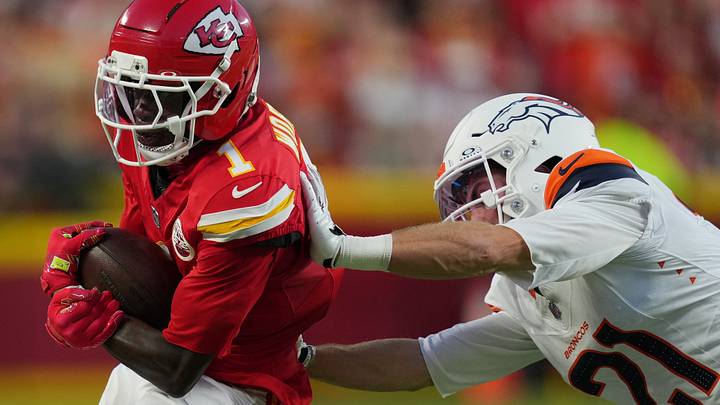 Sep 14, 2026; Kansas City, Missouri, USA;  Kansas City Chiefs wide receiver Xavier Worthy (1) makes a catch against Denver Broncos cornerback Riley Moss (21) in the first half at GEHA Field at Arrowhead Stadium.  Mandatory Credit: Jay Biggerstaff-Imagn Images