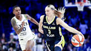 May 16, 2025; Arlington, Texas, USA;  Dallas Wings guard Paige Bueckers (5) dribbles as Minnesota Lynx guard Courtney Williams (10) defends during the second half at College Park Center. Mandatory Credit: Kevin Jairaj-Imagn Images
