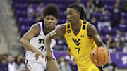 Feb 5, 2025; Fort Worth, Texas, USA;  West Virginia Mountaineers guard Javon Small (7) shoots the ball past TCU Horned Frogs guard Jace Posey (41) during the second half  at Ed and Rae Schollmaier Arena. Mandatory Credit: Kevin Jairaj-Imagn Images