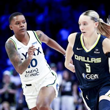 May 16, 2025; Arlington, Texas, USA;  Dallas Wings guard Paige Bueckers (5) dribbles as Minnesota Lynx guard Courtney Williams (10) defends during the second half at College Park Center. Mandatory Credit: Kevin Jairaj-Imagn Images
