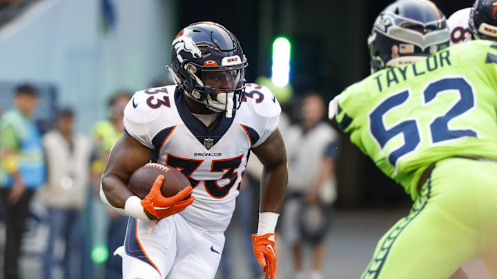 Sep 12, 2022; Seattle, Washington, USA; Denver Broncos running back Javonte Williams (33) rushes against the Seattle Seahawks during the first quarter at Lumen Field. 