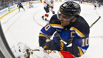 Feb 6, 2025; St. Louis, Missouri, USA;  St. Louis Blues center Brayden Schenn (10) checks Florida Panthers center Jesper Boqvist (70) during the second period at Enterprise Center. Mandatory Credit: Jeff Curry-Imagn Images