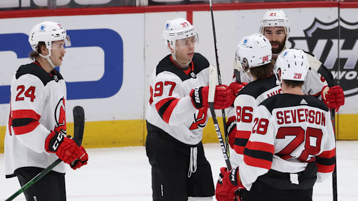 Feb 21, 2021; Washington, District of Columbia, USA; New Jersey Devils left wing Nikita Gusev (97) celebrates with teammates after scoring a goal against the Washington Capitals in the third period at Capital One Arena. Mandatory Credit: Geoff Burke-Imagn Images