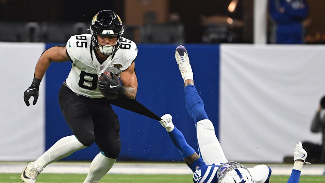 Jan 5, 2025; Indianapolis, Indiana, USA; Indianapolis Colts cornerback Jaylon Jones (40) grabs the jersey of Jacksonville Jaguars tight end Brenton Strange (85) in an attempt to tackle during the second half at Lucas Oil Stadium. Mandatory Credit: Marc Lebryk-Imagn Images