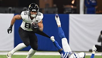 Jan 5, 2025; Indianapolis, Indiana, USA; Indianapolis Colts cornerback Jaylon Jones (40) grabs the jersey of Jacksonville Jaguars tight end Brenton Strange (85) in an attempt to tackle during the second half at Lucas Oil Stadium. Mandatory Credit: Marc Lebryk-Imagn Images