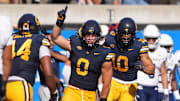 Cade Uluave celebrates after making an interception last fall.